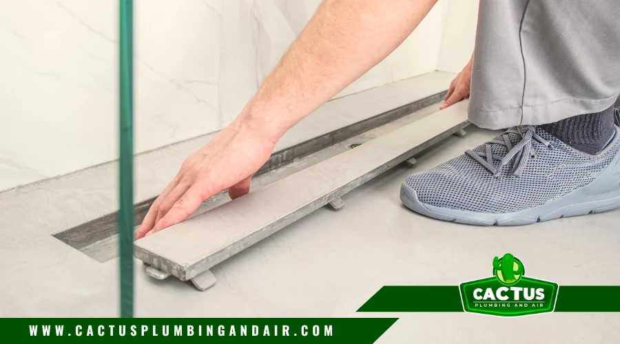 Plumber inspecting modern shower drain