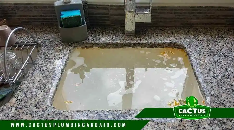 Slow draining sink with water backup