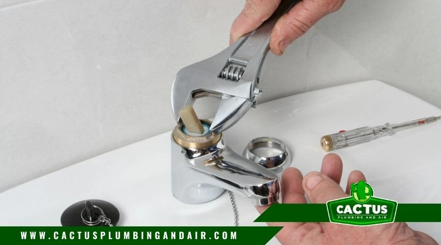 professional plumber of Cactus Plumbing and Air fixing a faucet